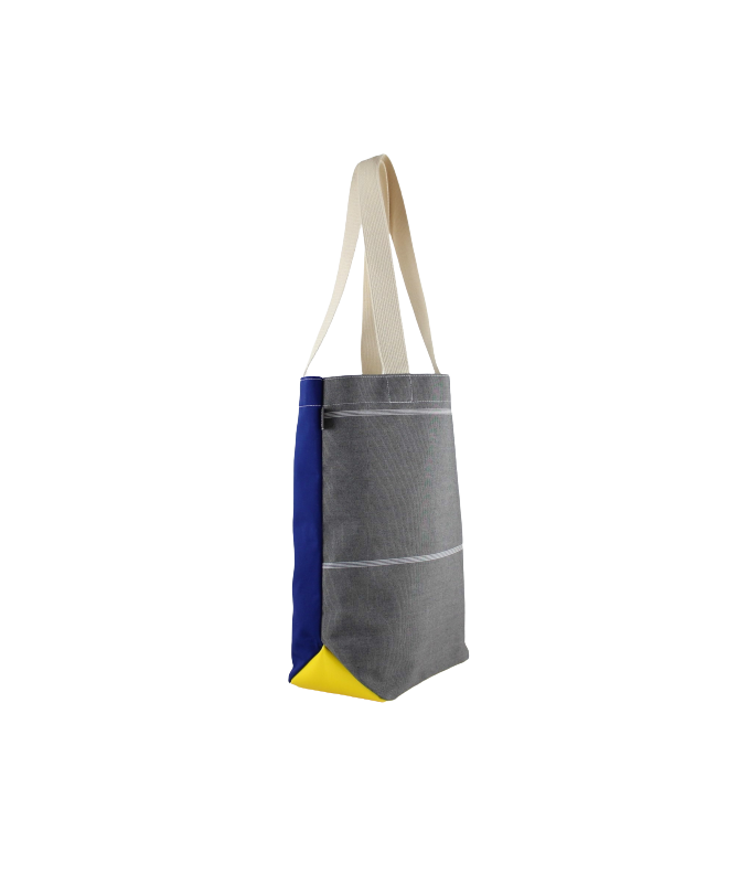 Vue de côté du sac isocèle gros, bleu et jaune en toile de store et vêtement de travail  upcyclés
